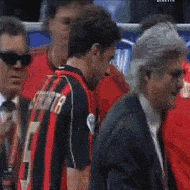 a man in a red and black jersey with the number 7 on the back