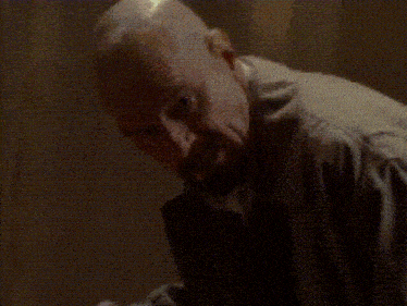 a blurred image of a person in a dark room with a light shining on them