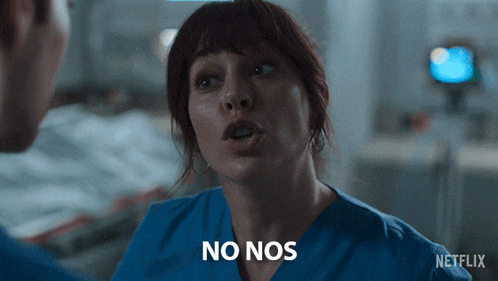 a woman in scrubs says no nos in front of a man