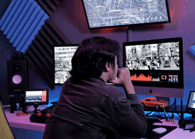a man sitting in front of a computer monitor that says c3 motion