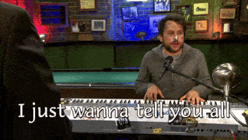 a man playing a keyboard with the words i just wanna tell you all written below him