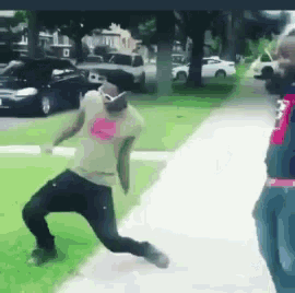 a man in a white shirt with a pink heart on it is running down a sidewalk