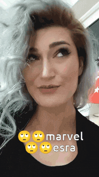 a close up of a woman 's face with the words " marvel esra " on her chest