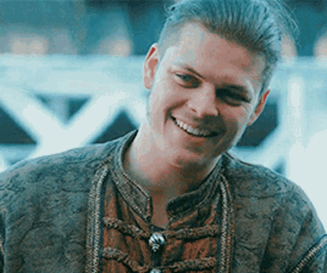 a close up of a man wearing a jacket and smiling .