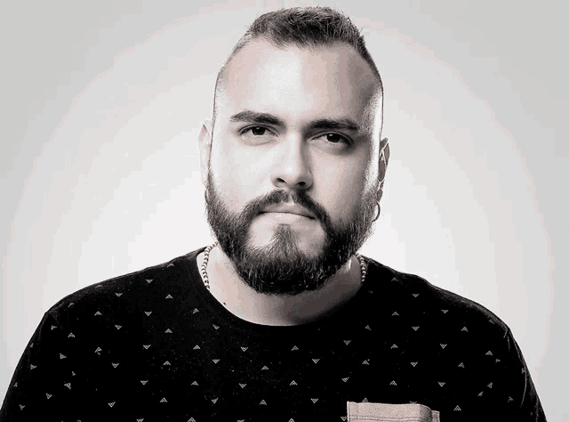 a man with a beard wearing a black shirt