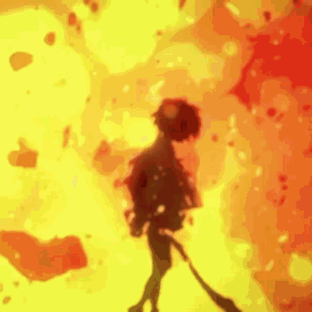 a silhouette of a person holding a sword in front of a fire explosion .