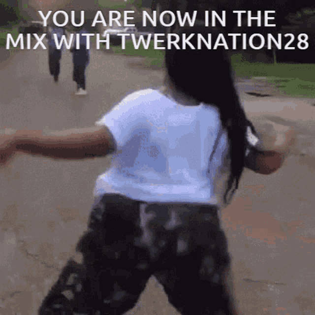 a woman is dancing in a park with the words you are now in the mix with twerknation29 written on the bottom