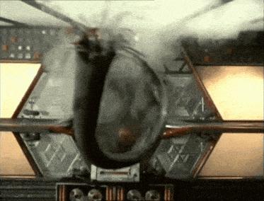 a helicopter is flying through the air and smoke is coming out of it .