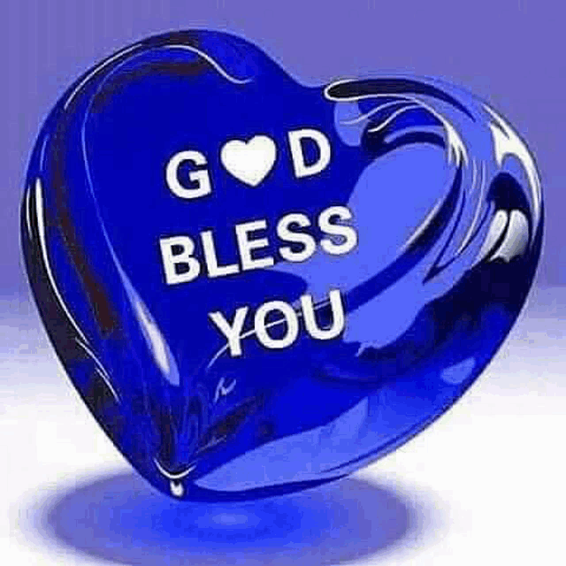 a blue heart shaped object with the words `` god bless you '' written on it .