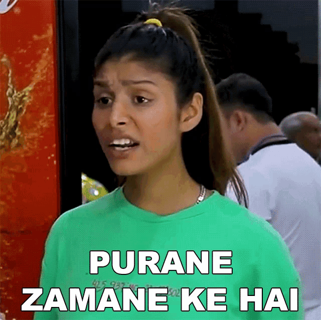 a woman wearing a green shirt with the words purane zamane ke hai on it