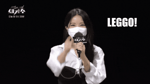 a woman wearing a face mask is holding a microphone and the word leggo is above her