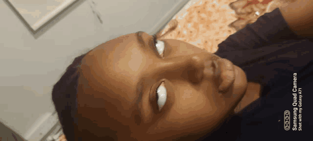 a close up of a person 's face with the words samsung quad camera written on the bottom