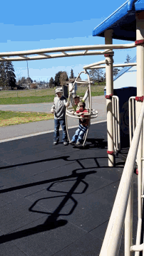a shadow of a bicycle is cast on the ground in a park
