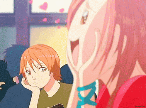 a girl covering her face with her hand while a boy looks on ..