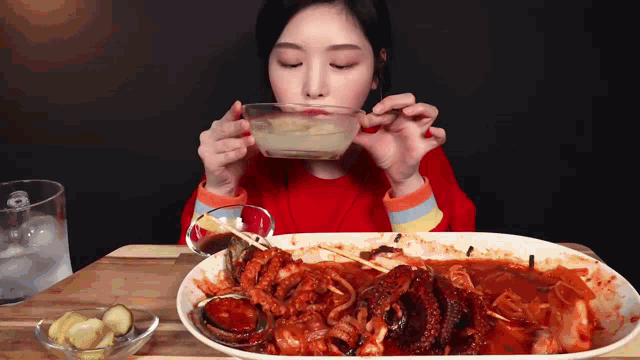 a woman is eating a large plate of food
