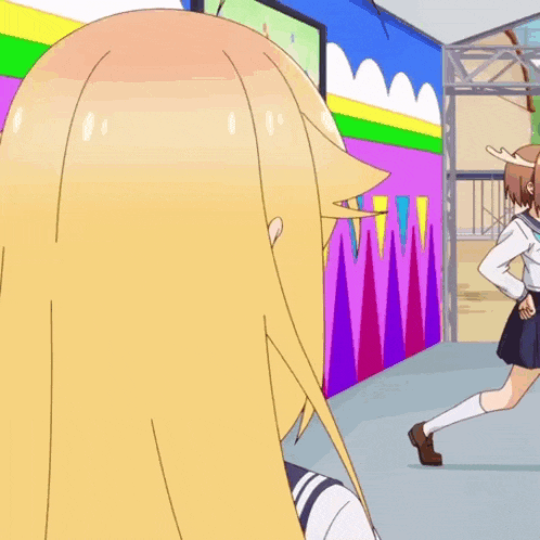 a girl with long blonde hair is looking at another girl
