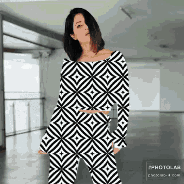 a woman is wearing a black and white patterned outfit