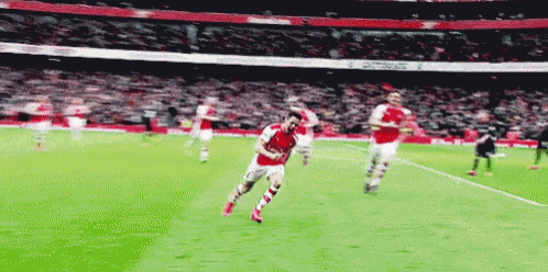 a soccer player wearing a red jersey with the word arsenal on the front