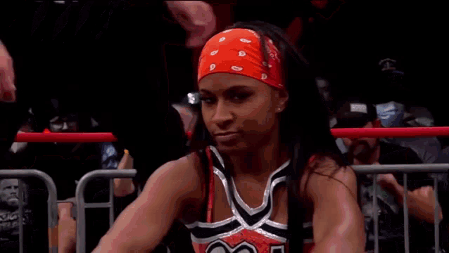 a female wrestler wearing a red bandana with the letter d on it