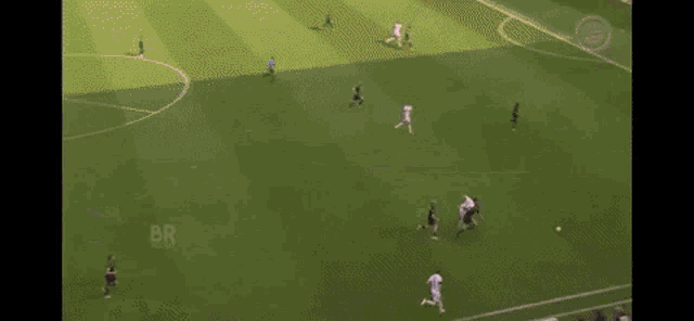 a group of soccer players are running after a soccer ball