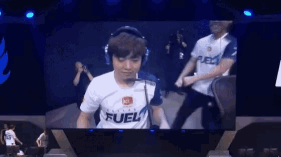 a man wearing headphones and a white shirt that says fuel