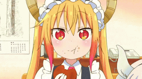 a girl with horns is eating a piece of food with her mouth .