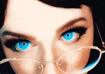 a close up of a woman 's face with blue eyes and glasses