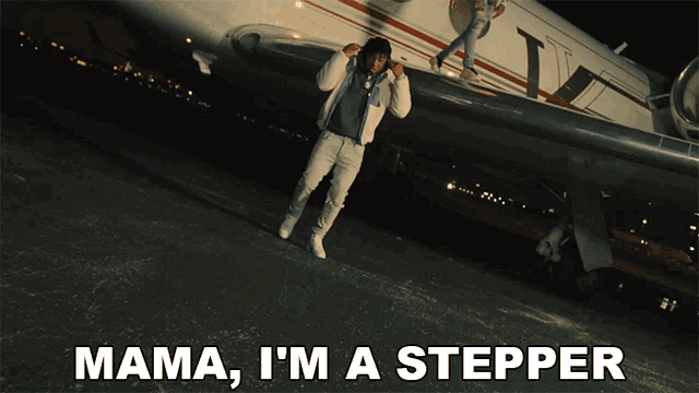 a man is standing in front of a plane with the words mama i 'm a stepper below him