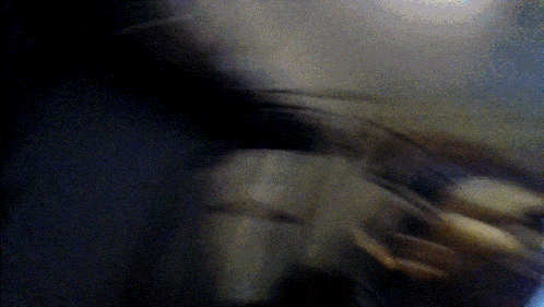 a blurry picture of a person in a dark room with a blue background