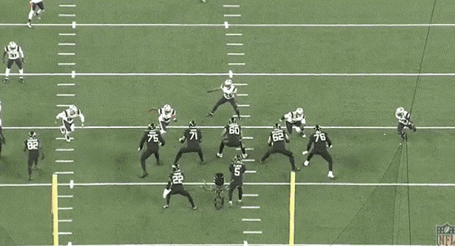 a group of football players are playing on a field and one of the players has the number 60 on his jersey