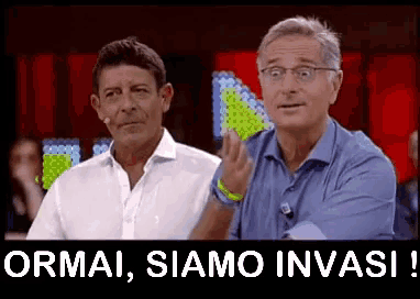 two men are standing next to each other with the words " ormai siamo invasi " in the corner