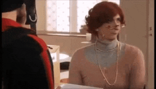 a man and a woman are talking to each other in a room .