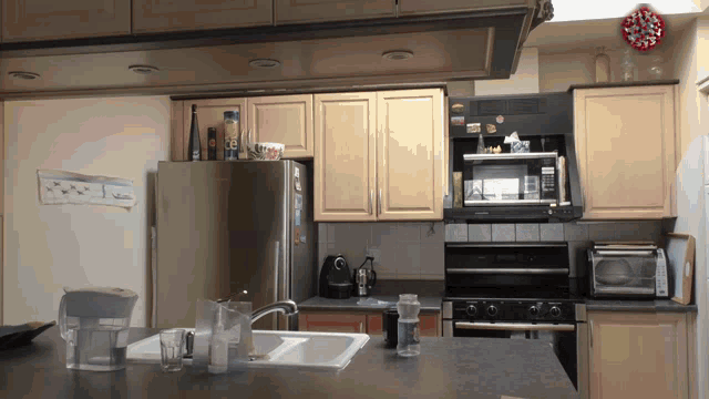 a kitchen with a microwave and a refrigerator with a sticker that says ' i love you '