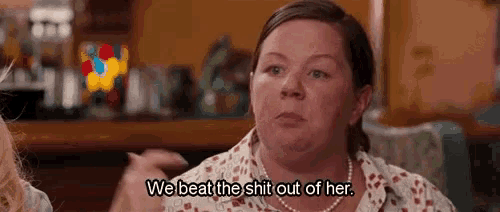 a woman is sitting at a table talking to another woman .