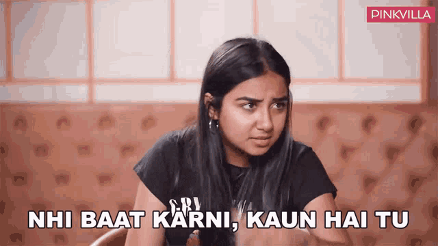 a woman sitting at a table with the words " nhi baat karni kaun hai tu " written on the bottom