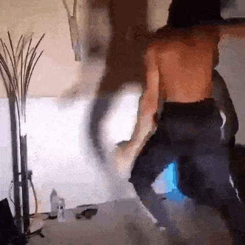 a man without a shirt is dancing on the floor