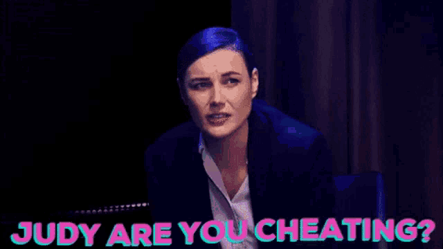 a woman sitting next to another woman with judy are you cheating written on the bottom