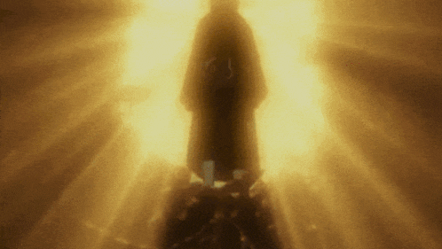 a person is standing in a dark room with a light shining on them .