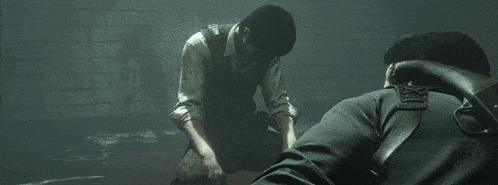 a man is holding a woman 's hand in the dark .