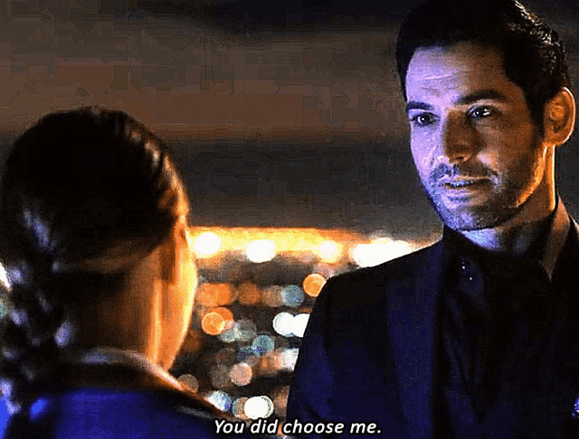 a man in a suit is talking to a woman in a blue shirt who is saying you did choose me