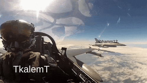 a fighter jet is flying in the sky with the name tkalemt on the bottom right