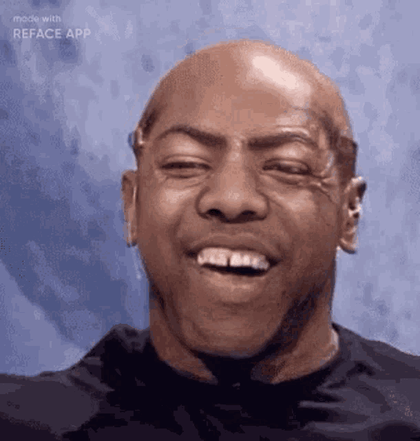 a bald man with no teeth is smiling with his mouth open .