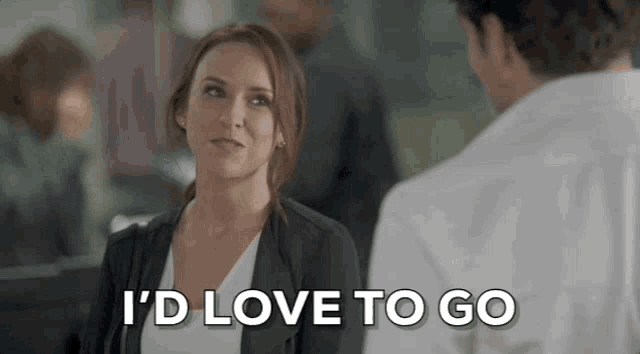 a woman is talking to a man in a white shirt and says `` i 'd love to go '' .