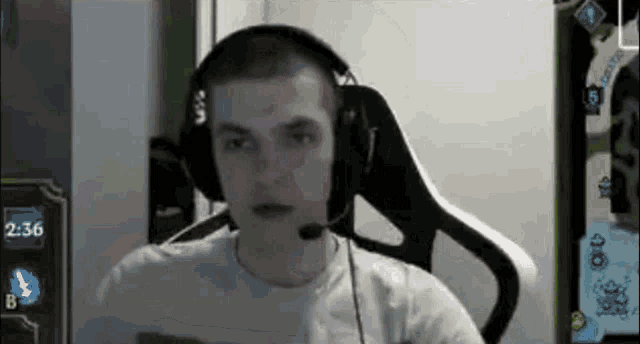 a man wearing headphones is sitting in a chair .