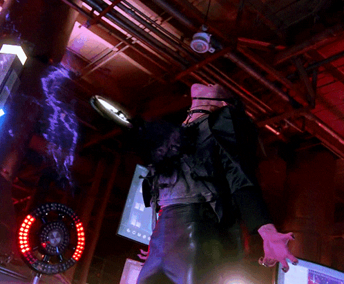 a woman screaming in a dark room with a circle of lights behind her