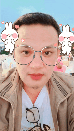 a man wearing glasses and a jacket with a bunny on his face