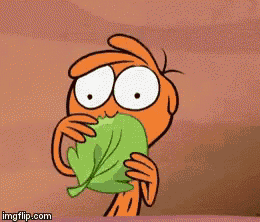 a cartoon character is holding a green leaf in front of his mouth .