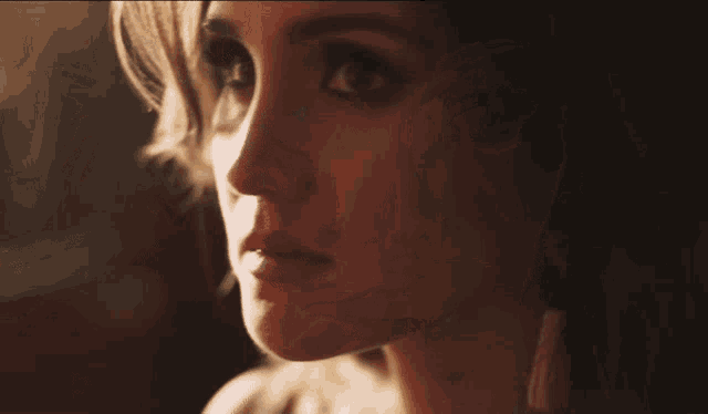 a close up of a woman 's face with a very serious look on her face