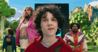 a boy with curly hair and a red hoodie stands in front of a group of men