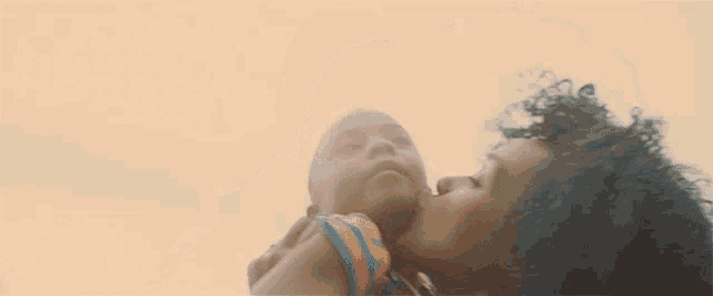 a woman kisses a child on the cheek